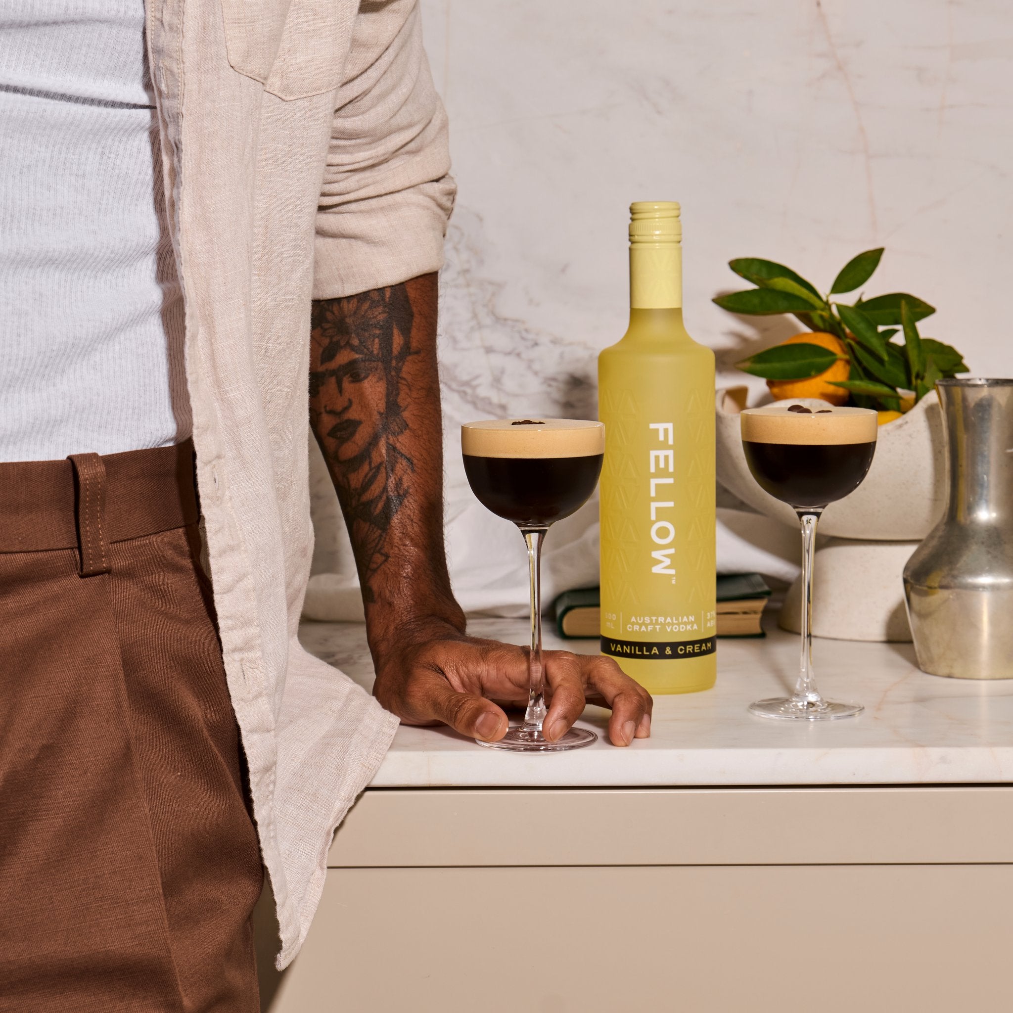 Man holding espresso martini made with Fellow Vanilla & Cream Vodka 